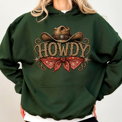 May include: A dark forest green hooded sweatshirt featuring a graphic print of a brown cowboy hat above the word HOWDY written in a rope-style font, with a red paisley bandana and two small silver-toned stars positioned below the text.