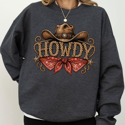 May include: A dark charcoal gray crewneck sweatshirt featuring a graphic print of a brown cowboy hat above the word HOWDY written in a rope-textured font, with a red paisley bandana and two small metallic stars positioned below the text.