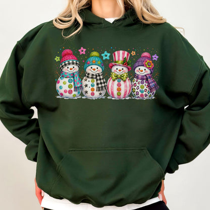 May include: A dark forest green hooded sweatshirt featuring a graphic print of four snowmen. Each snowman wears a unique hat and scarf, decorated with colorful buttons and surrounded by small, multi-colored star shapes across the chest area.