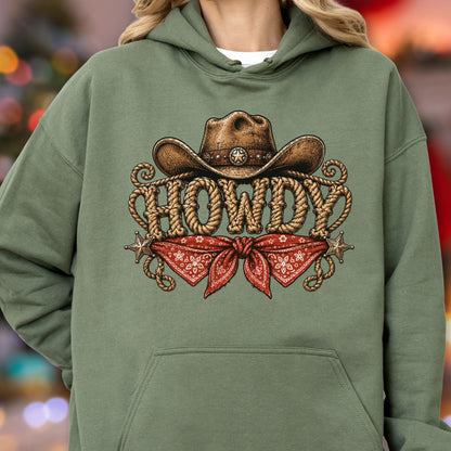 May include: An olive green hooded sweatshirt featuring a graphic print of a brown cowboy hat above the word HOWDY, which is written in a rope-style font. Below the text is a red bandana with a white pattern and two small star accents.