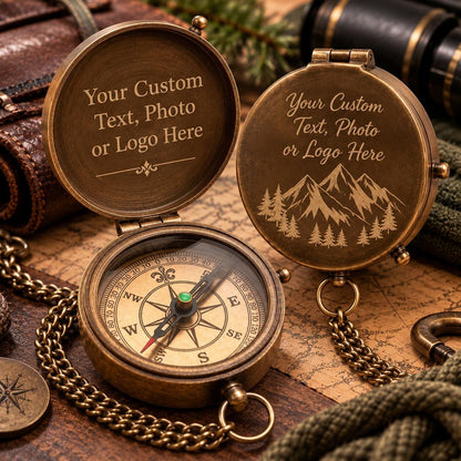May include: Two antique-style brass pocket compasses with chains. One is open, showing a directional dial with cardinal points. The other is closed, featuring an engraved mountain and forest scene. Both lids display the text Your Custom Text, Photo or Logo Here.